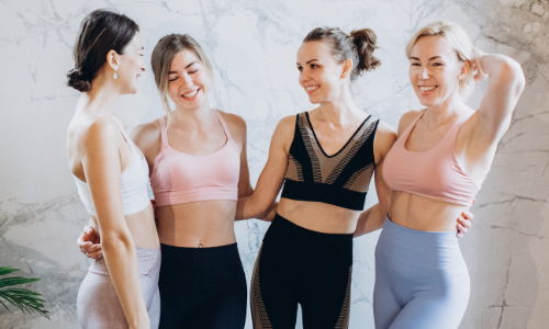 group of women in yoga outfits standing together